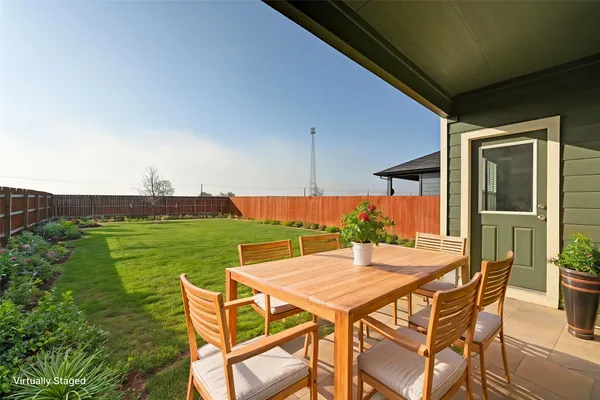 a patio with table and chairs