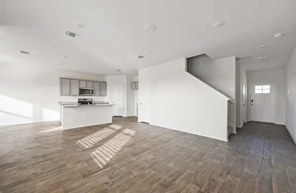 a view of a kitchen with wooden floor and a sink