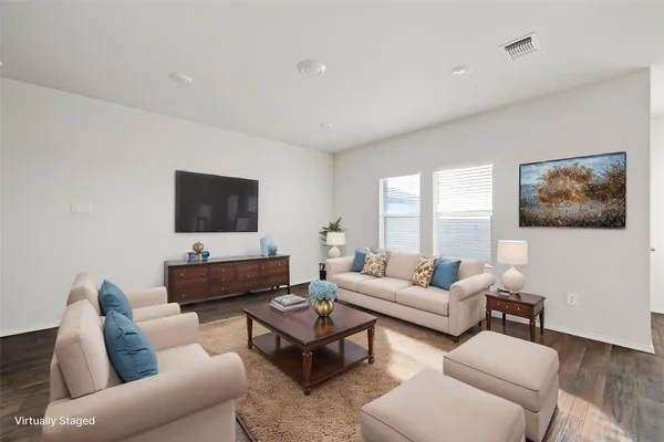 a living room with furniture couches and a flat screen tv