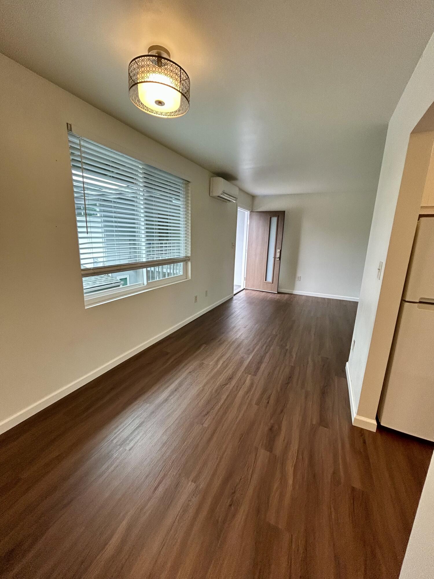 47 Ocean View Avenue, Unit 14 Santa Barbara, CA 93103 - Photo 5 of 9 a view of an empty room with wooden floor and a window