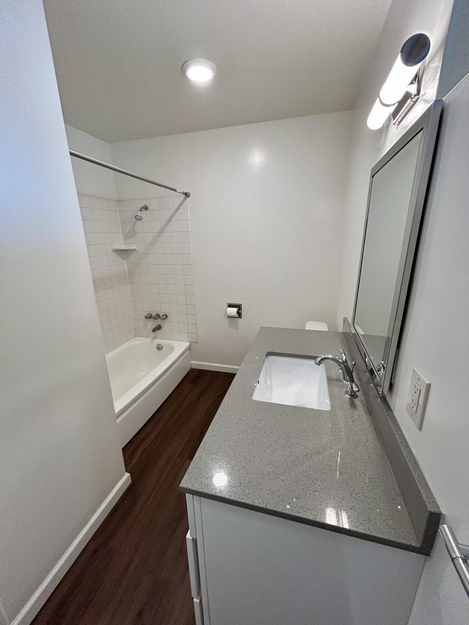 47 Ocean View Avenue, Unit 14 Santa Barbara, CA 93103 - Photo 8 of 9 a bathroom with a sink and mirror