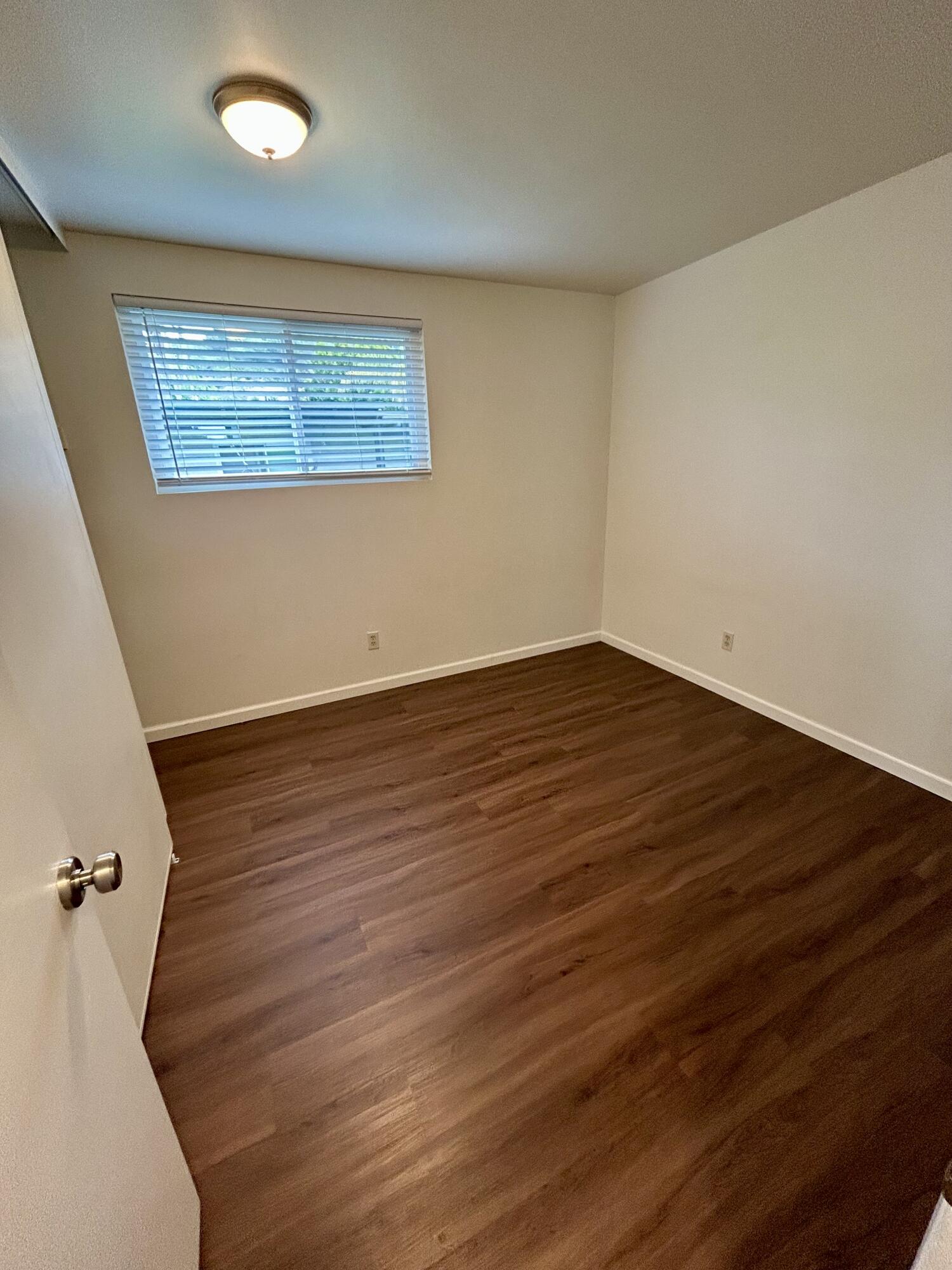 47 Ocean View Avenue, Unit 14 Santa Barbara, CA 93103 - Photo 9 of 9 a view of an empty room with wooden floor and a window