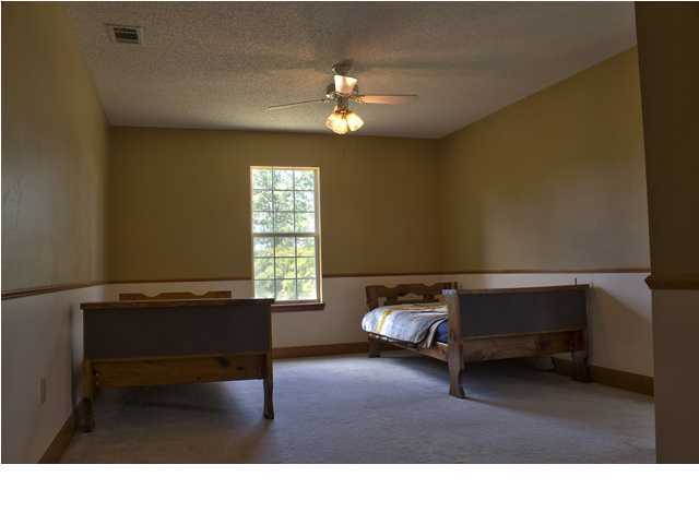 1490 Richardson Road DeFuniak Springs, FL 32433 - Photo 12 of 29 a living room with furniture and a chandelier