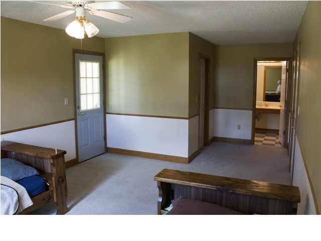 1490 Richardson Road DeFuniak Springs, FL 32433 - Photo 13 of 29 a living room with furniture and a chandelier