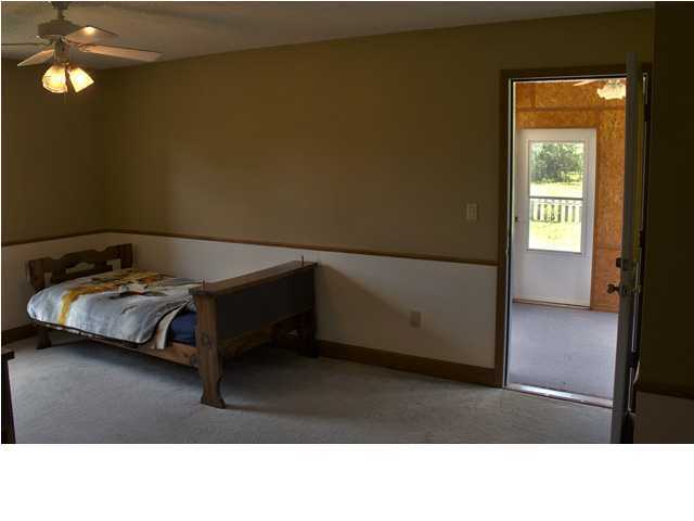 1490 Richardson Road DeFuniak Springs, FL 32433 - Photo 14 of 29 a living room with a bed and a window