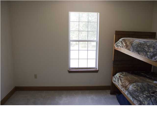 1490 Richardson Road DeFuniak Springs, FL 32433 - Photo 16 of 29 a living room with a bed furniture and a window
