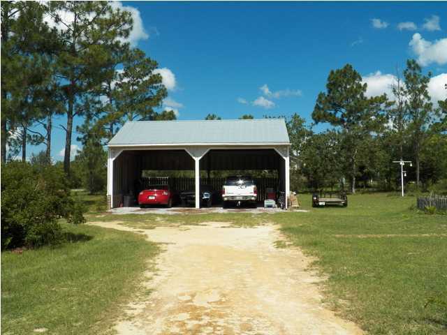 1490 Richardson Road DeFuniak Springs, FL 32433 - Photo 19 of 29 a view of a house with a yard and sitting area