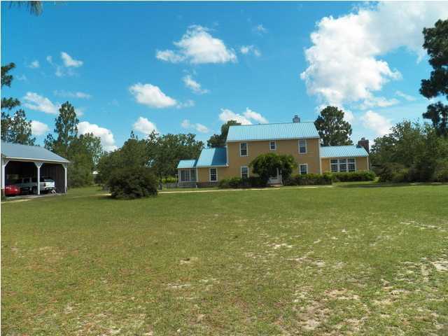 1490 Richardson Road DeFuniak Springs, FL 32433 - Photo 21 of 29 a front view of a house with garden