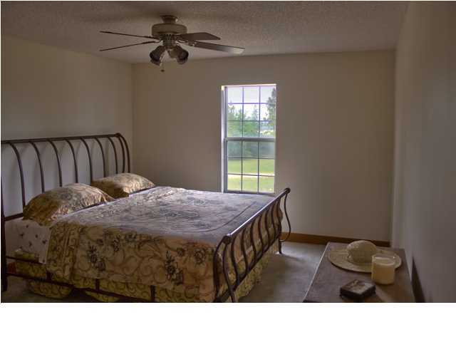 1490 Richardson Road DeFuniak Springs, FL 32433 - Photo 10 of 29 a living room with a bed furniture and a window