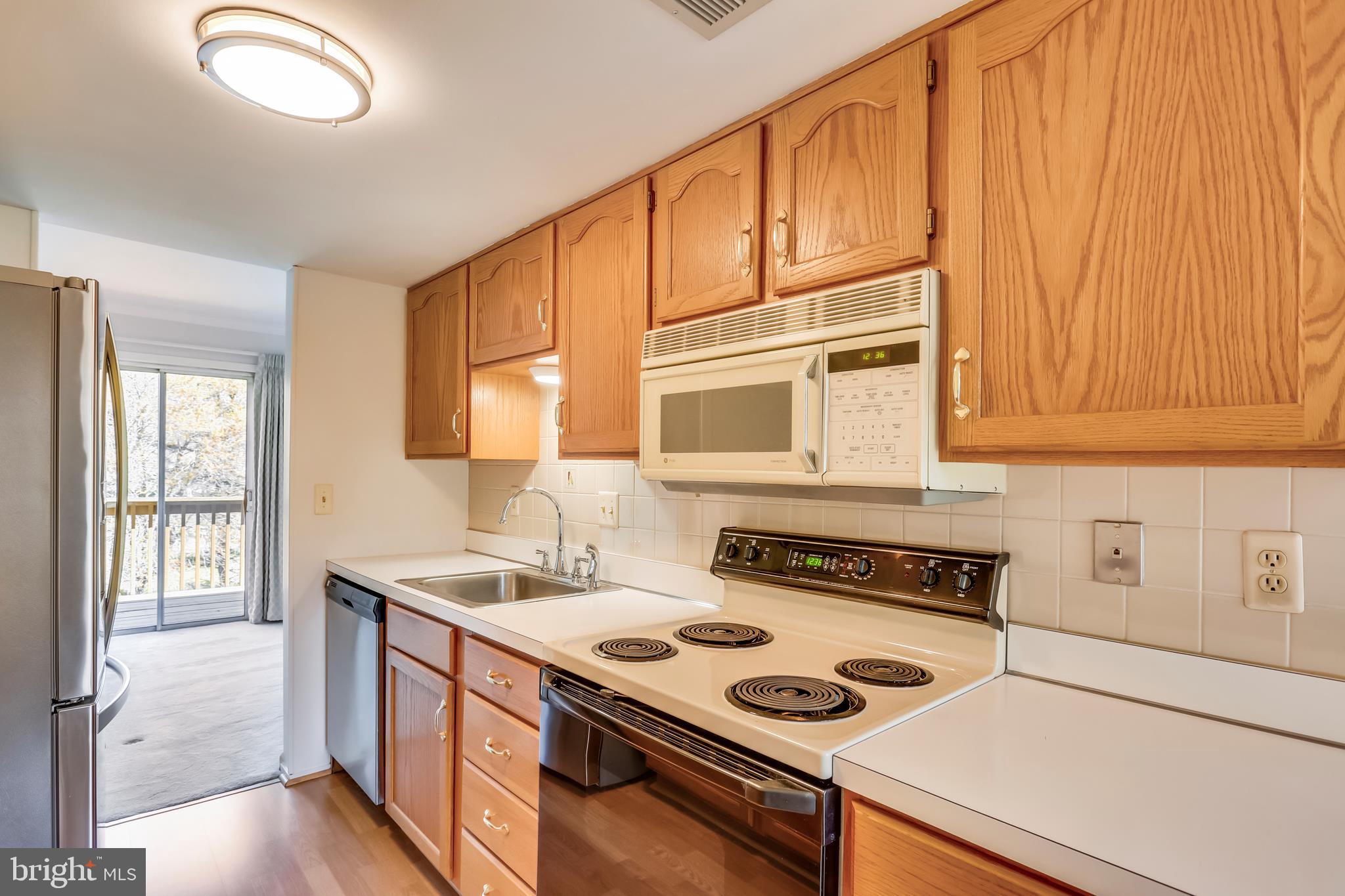 Galley kitchen leads to living room