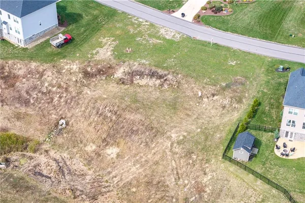 an aerial view of a house with yard swimming pool and outdoor seating
