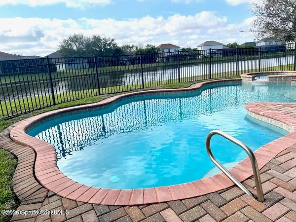 a view of a swimming pool with a lounge chair