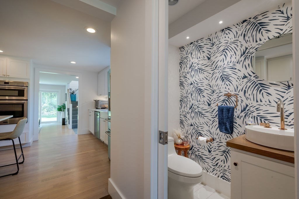 29 Water Street Natick, MA 01760 - Photo 12 of 42 a bathroom with a toilet sink and mirror