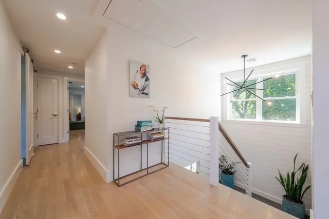 a spacious bedroom with a bed a mirror and lamp