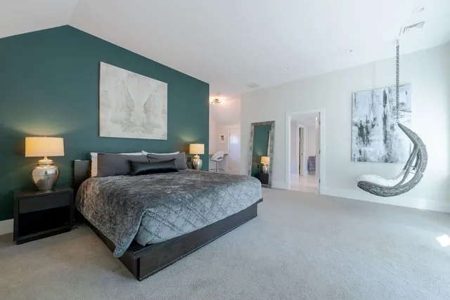 a spacious bathroom with a double vanity sink a mirror and a bathtub
