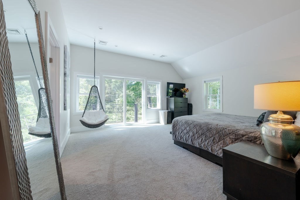 29 Water Street Natick, MA 01760 - Photo 18 of 42 a bedroom with a bed and large windows