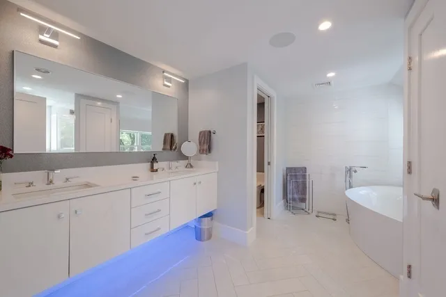 a bedroom with a bed a table and a window