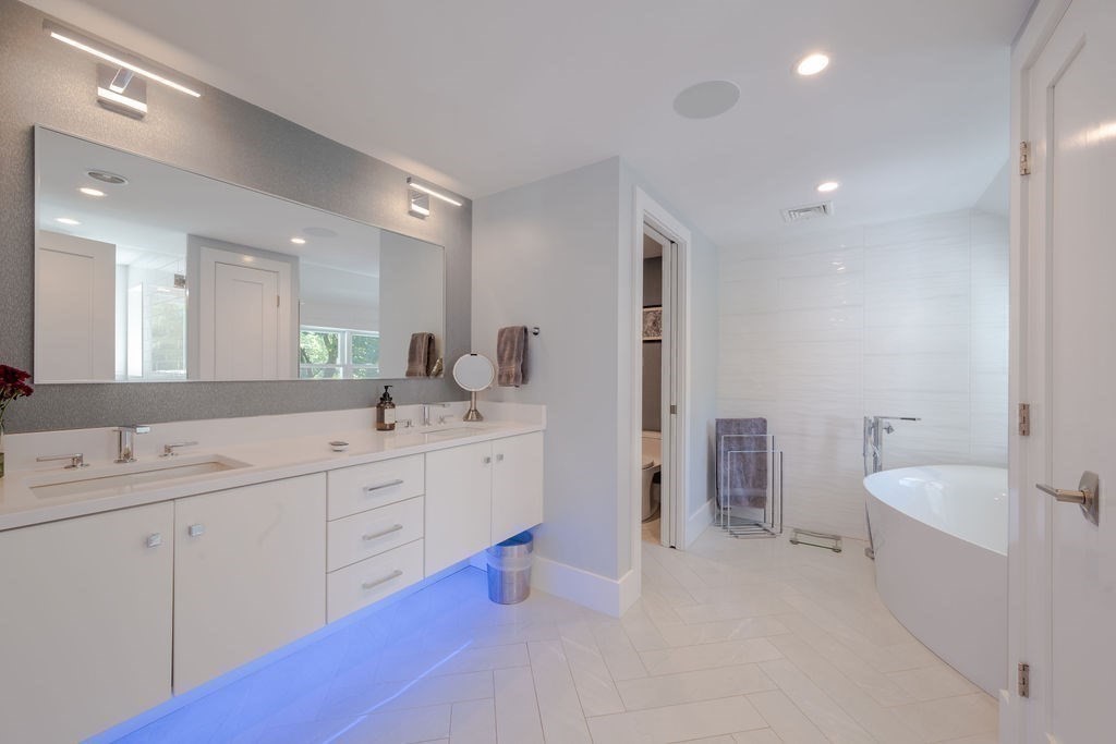 29 Water Street Natick, MA 01760 - Photo 20 of 42 a spacious bathroom with a double vanity sink a mirror and a bathtub