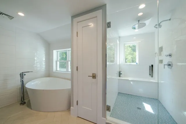 a bedroom with a bed and a chair in it