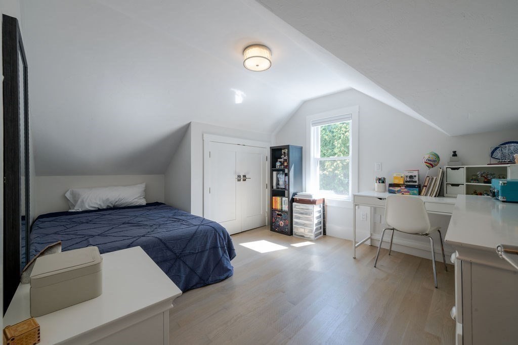 29 Water Street Natick, MA 01760 - Photo 24 of 42 a bedroom with a bed and a chair in it