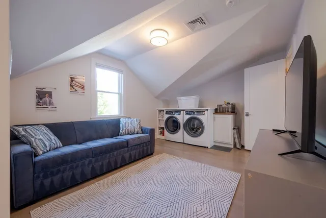an aerial view of residential house with outdoor space and trees all around