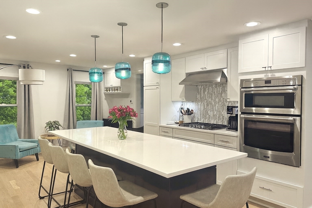 29 Water Street Natick, MA 01760 - Photo 7 of 42 a kitchen with a dining table chairs sink and stove
