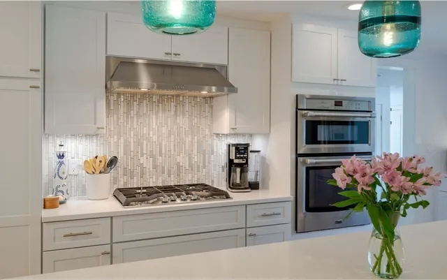 a kitchen with stainless steel appliances a refrigerator sink and stove