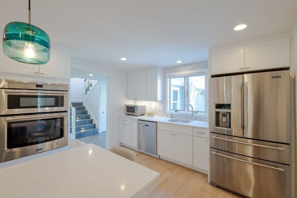 29 Water Street Natick, MA 01760 - Photo 9 of 42 a kitchen with stainless steel appliances a refrigerator sink and stove