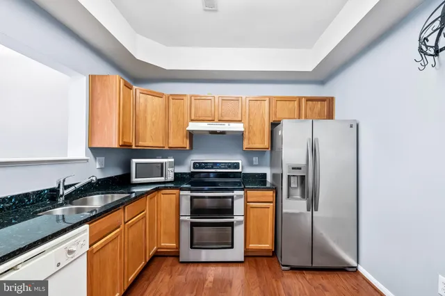 a kitchen with a sink stove and refrigerator