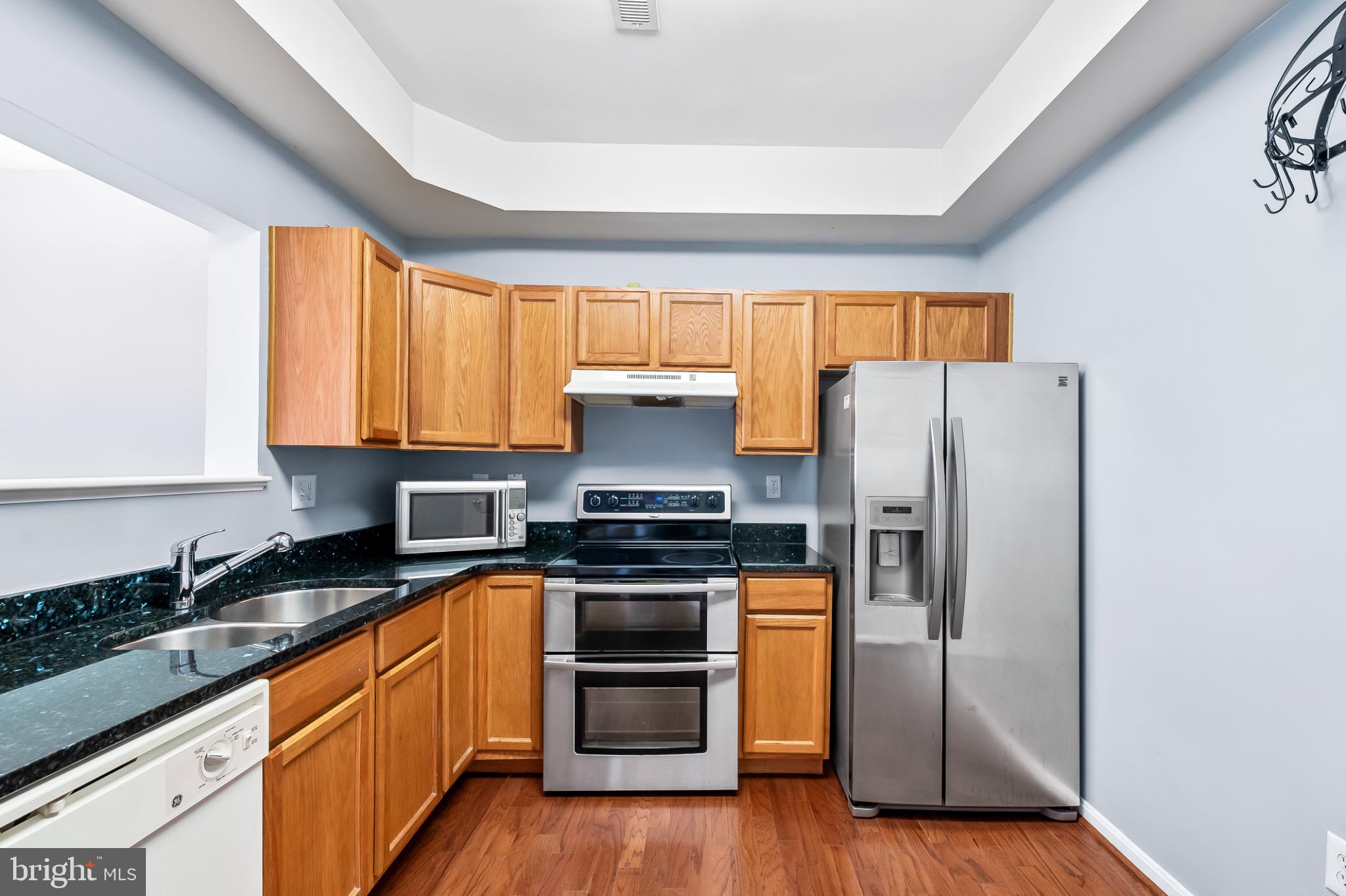 1913 Camelia Court Odenton, MD 21113 - Photo 11 of 26 a kitchen with stainless steel appliances granite countertop a refrigerator stove and sink