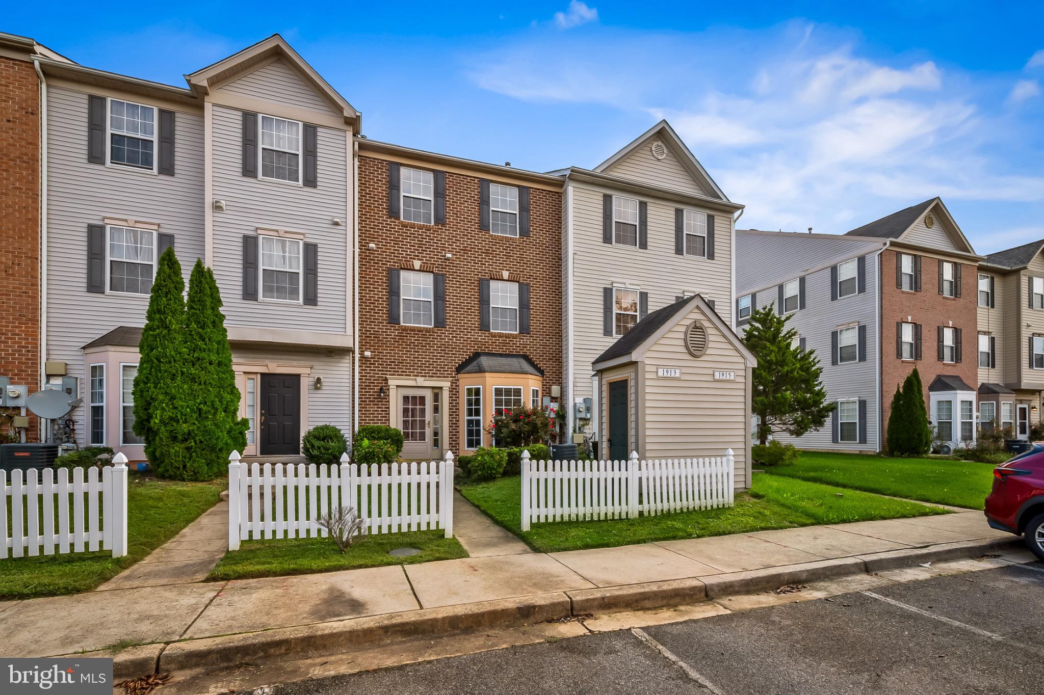 1913 Camelia Court Odenton, MD 21113 - Photo 2 of 26 a front view of a house with a garden and fence
