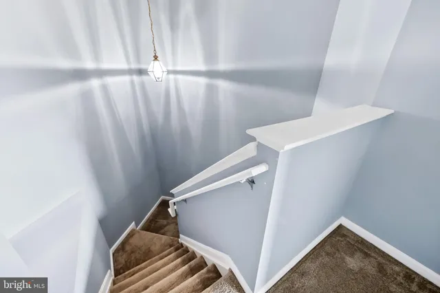 an empty room with windows and ceiling fan
