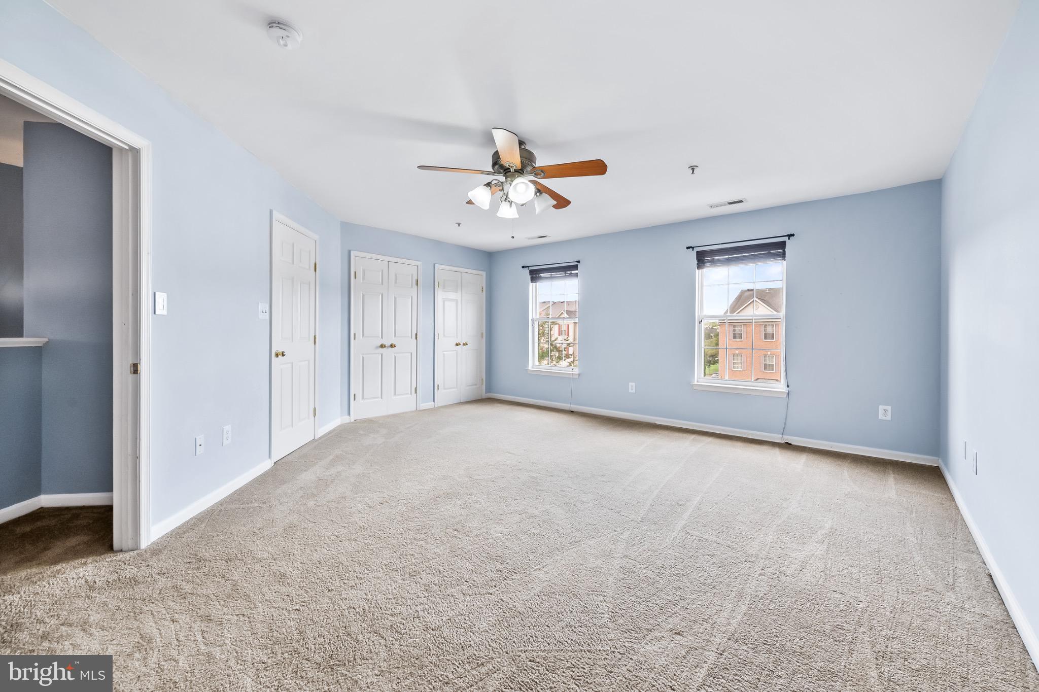 1913 Camelia Court Odenton, MD 21113 - Photo 22 of 26 an empty room with windows and ceiling fan