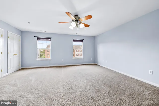 a view of a livingroom with a chandelier fan
