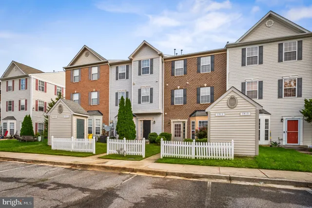a view of a brick house with potted plants