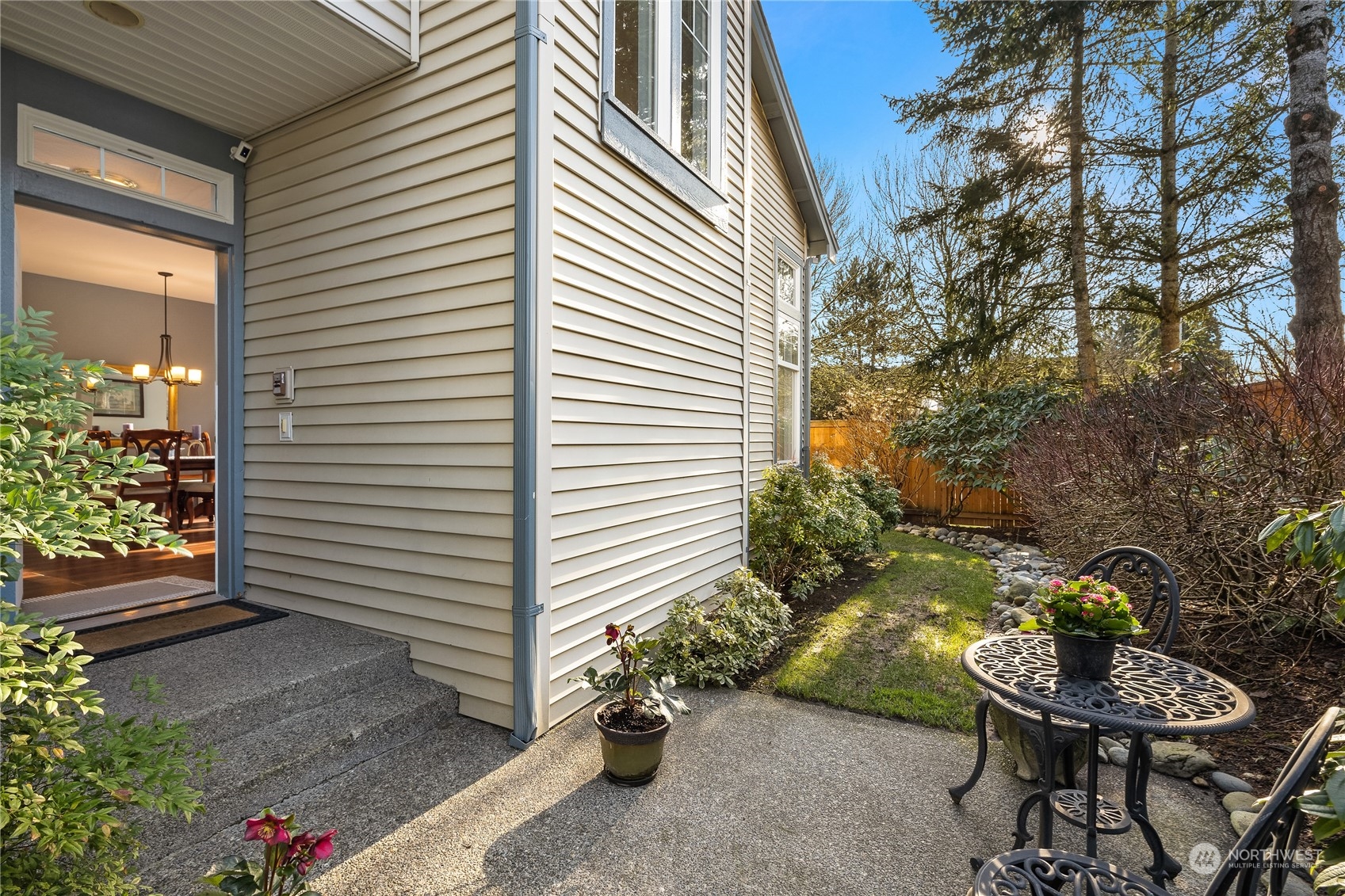 4601 Northeast 6th Court Renton, WA 98059 - Photo 3 of 40 a backyard with table and chairs and potted plants