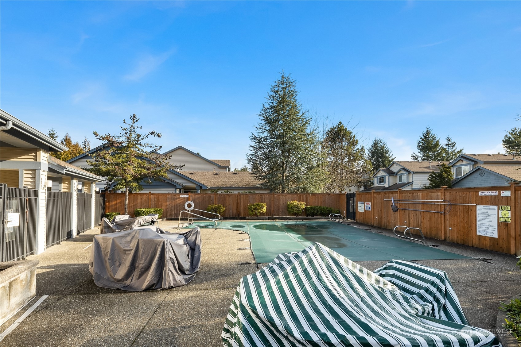 4601 Northeast 6th Court Renton, WA 98059 - Photo 37 of 40 a view of a patio with table and chairs with wooden floor and fence