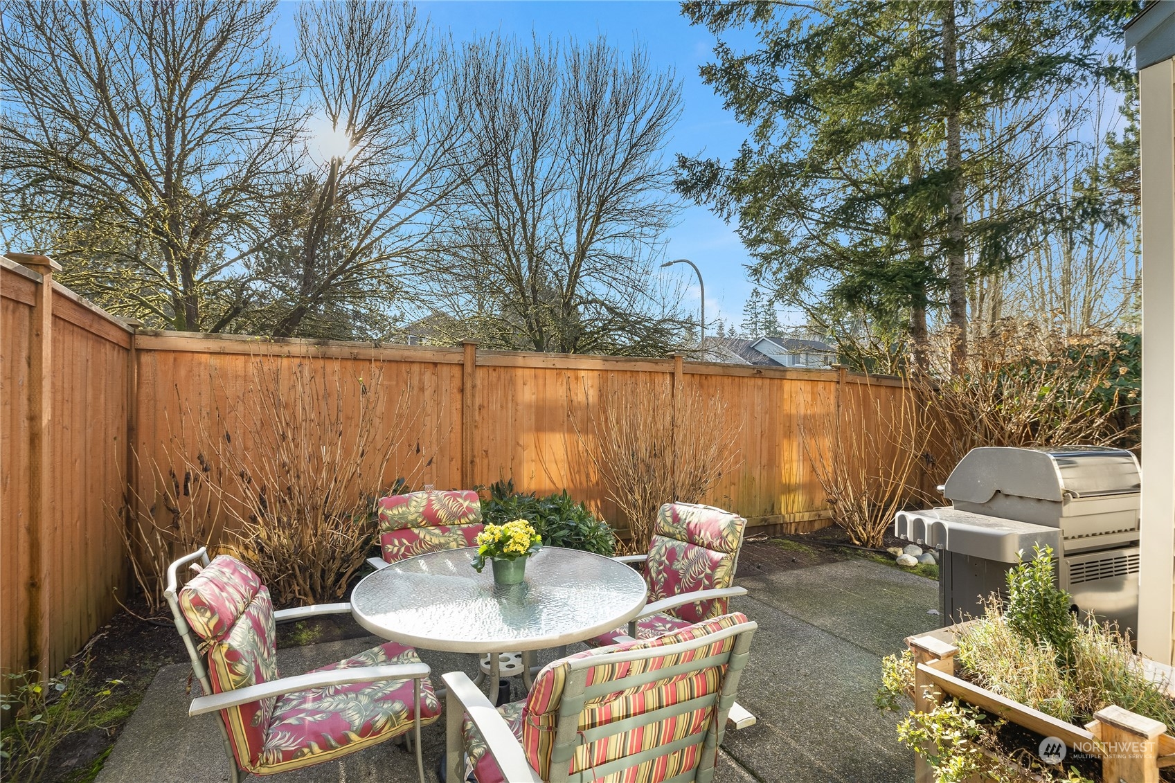 4601 Northeast 6th Court Renton, WA 98059 - Photo 7 of 40 a backyard of a house with table and chairs