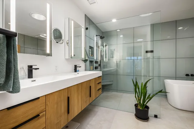 a kitchen with stainless steel appliances kitchen island granite countertop a dining table and chairs in it