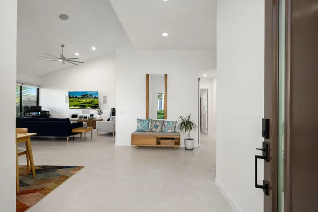 a front view of a house with a yard and mountain