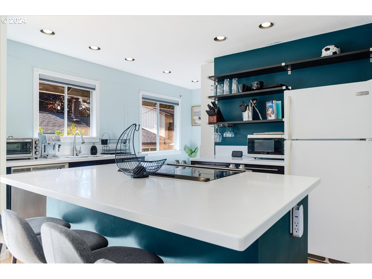 2675 Southwest Spring Garden Street Portland, OR 97219 - Photo 15 of 31 a kitchen with stainless steel appliances a sink and a refrigerator