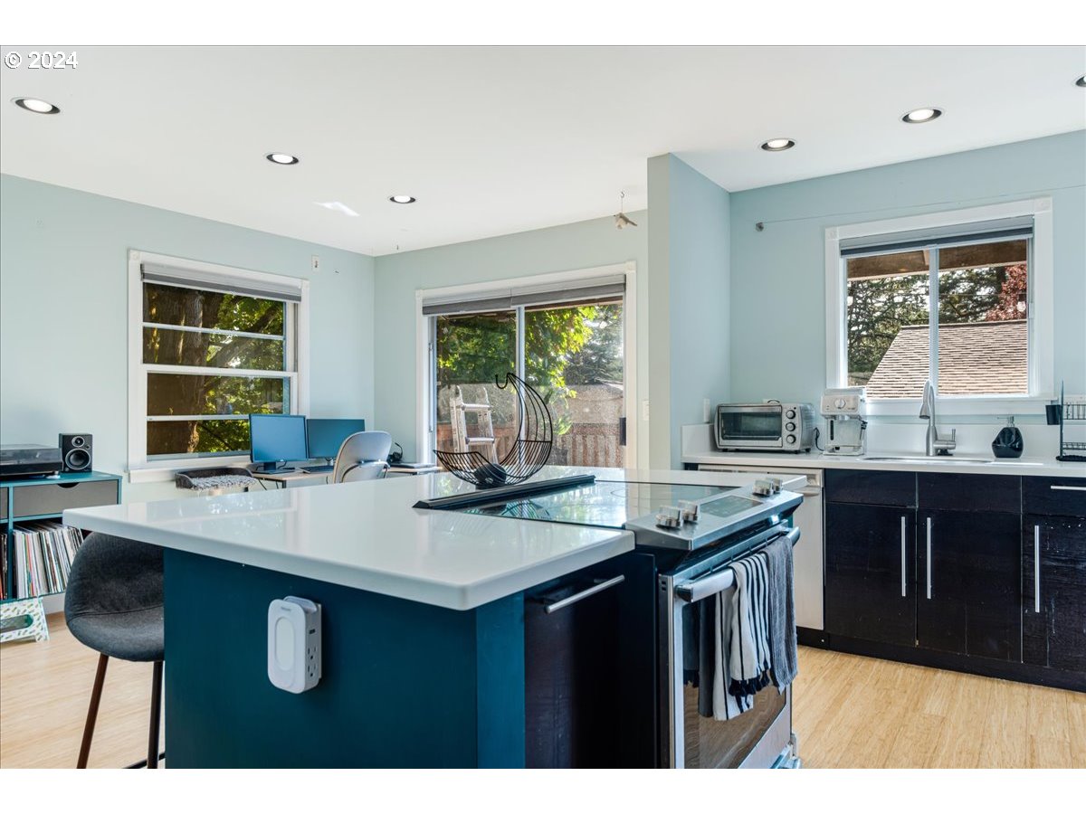 2675 Southwest Spring Garden Street Portland, OR 97219 - Photo 16 of 31 a kitchen with a sink a window and chairs