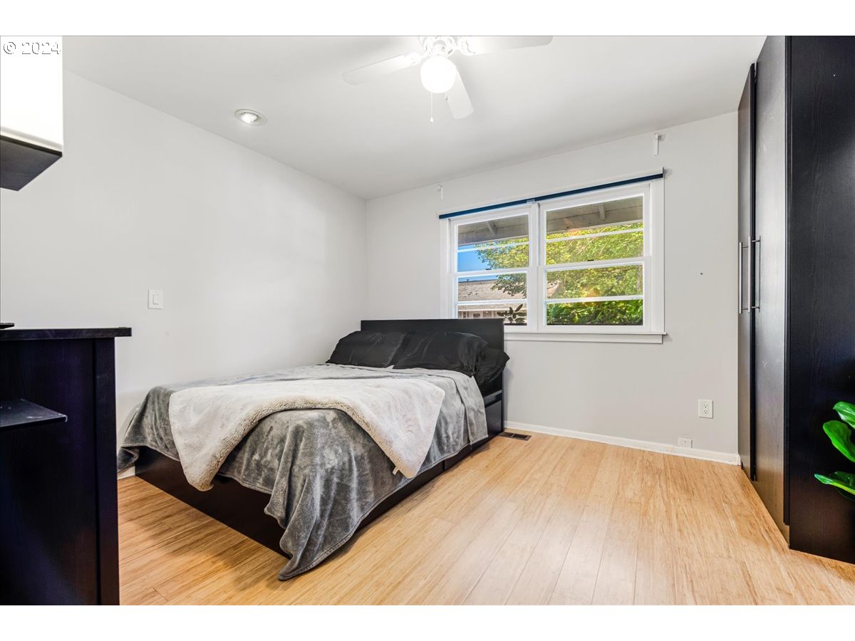 2675 Southwest Spring Garden Street Portland, OR 97219 - Photo 20 of 31 a bedroom with a bed and wooden floor