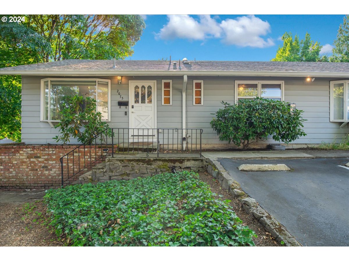 2675 Southwest Spring Garden Street Portland, OR 97219 - Photo 2 of 31 a view of a house with a yard and sitting area