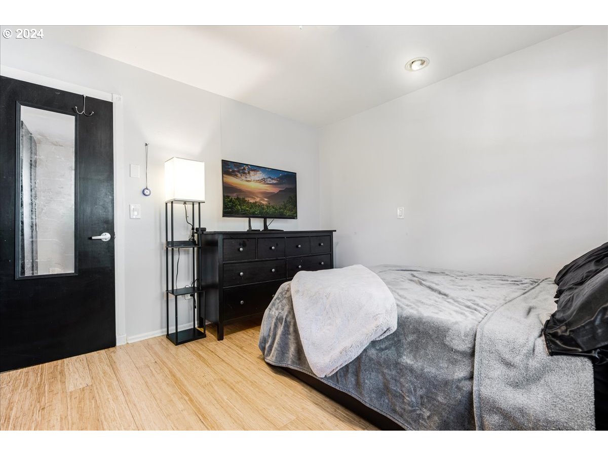 2675 Southwest Spring Garden Street Portland, OR 97219 - Photo 21 of 31 a bedroom with a bed and a flat screen tv