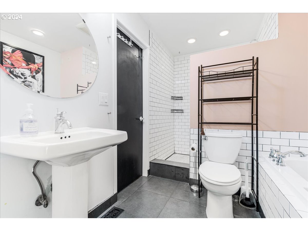 2675 Southwest Spring Garden Street Portland, OR 97219 - Photo 23 of 31 a bathroom with a toilet a sink and mirror