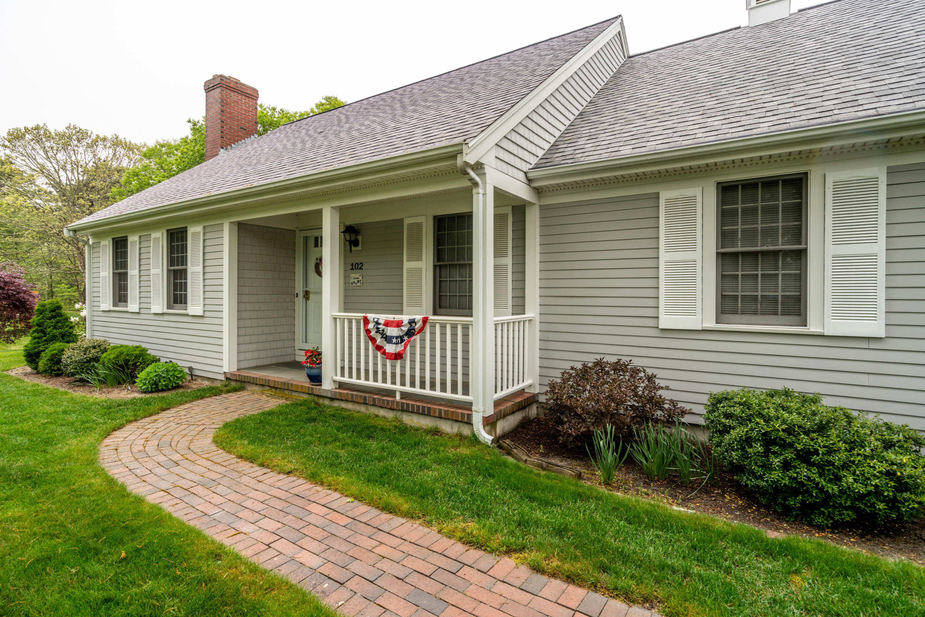 a front view of a house with garden