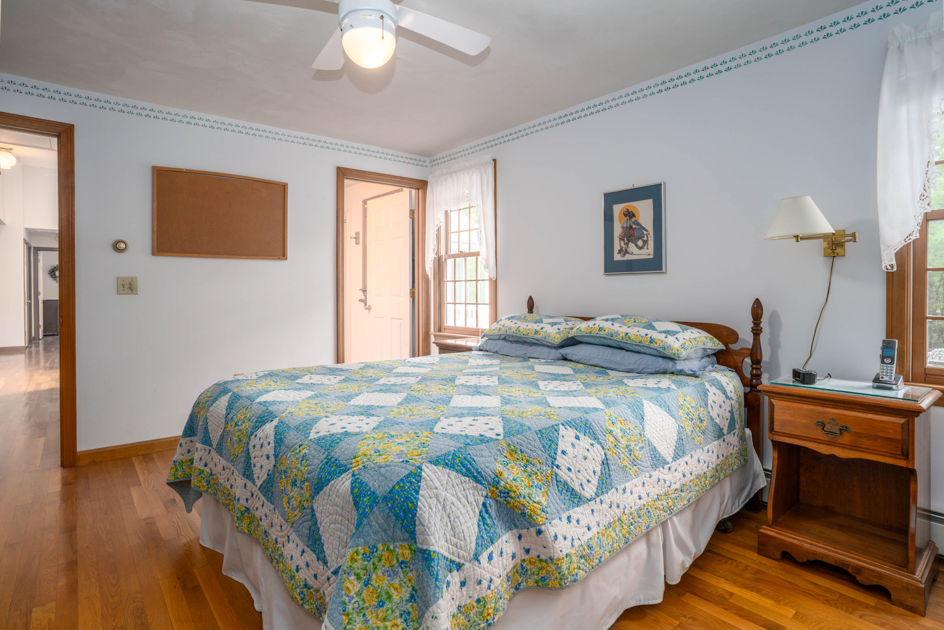 102 Long Hill Road Dennis, MA 02638 - Photo 12 of 24 a bedroom with a bed and wooden floor