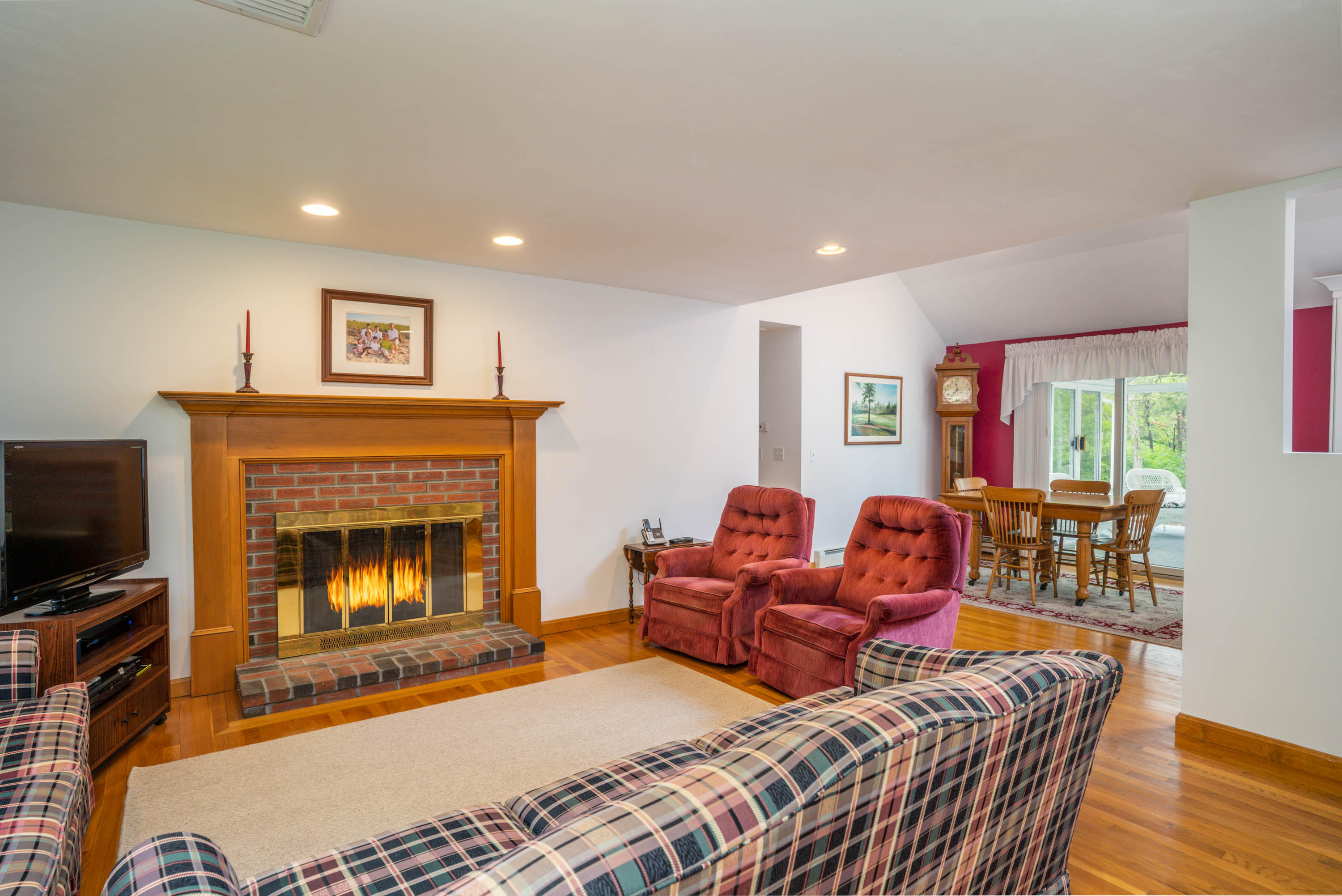 102 Long Hill Road Dennis, MA 02638 - Photo 4 of 24 a living room with furniture a fireplace and a flat screen tv