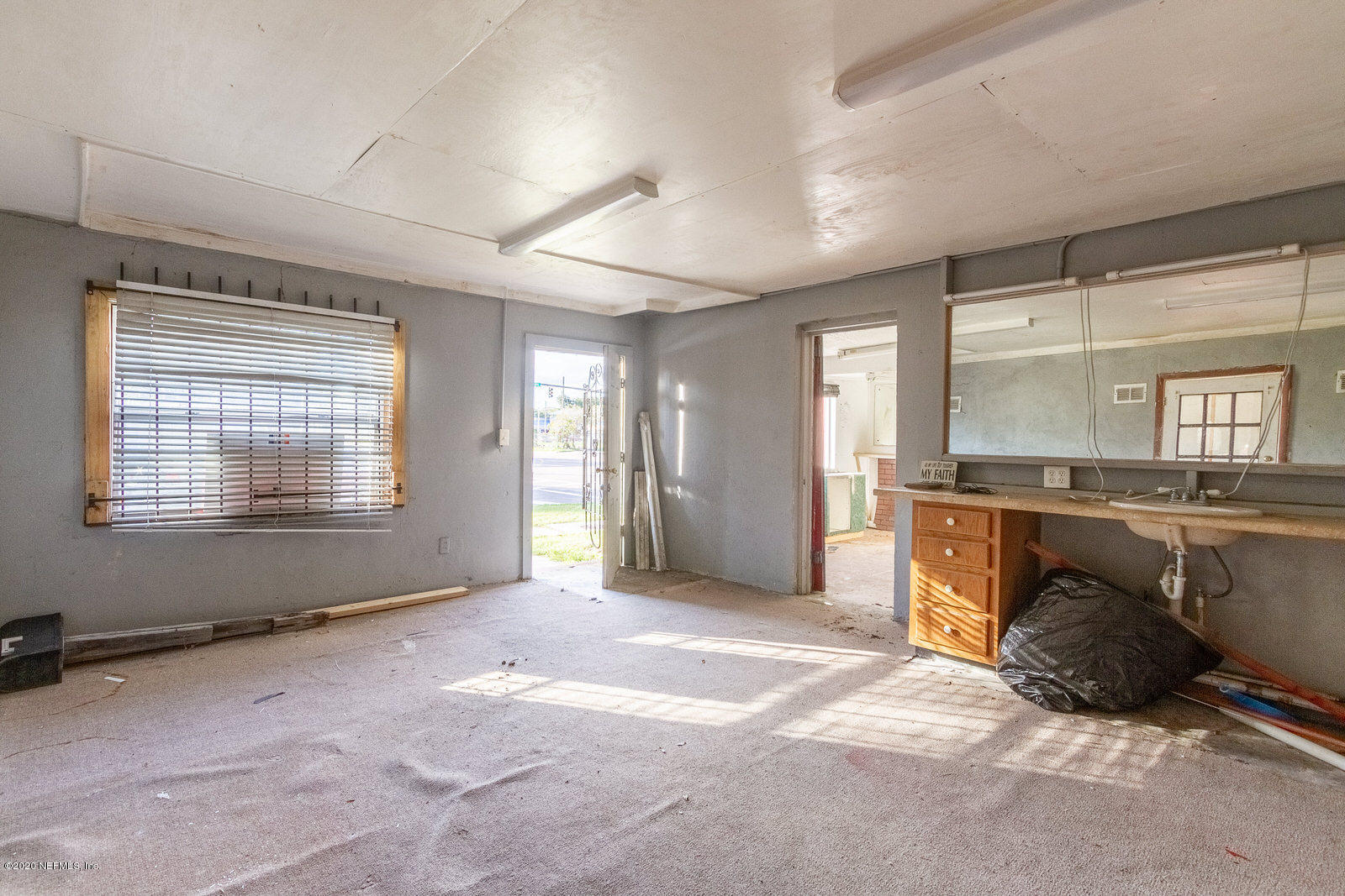 2905 Moncrief Road Jacksonville, FL 32209 - Photo 7 of 82 a view of an empty room with a fireplace and a window